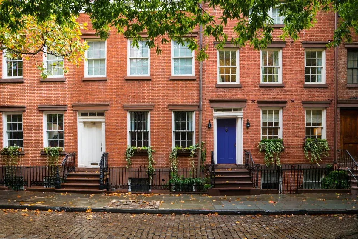 West Village brick townhouses with a blue door