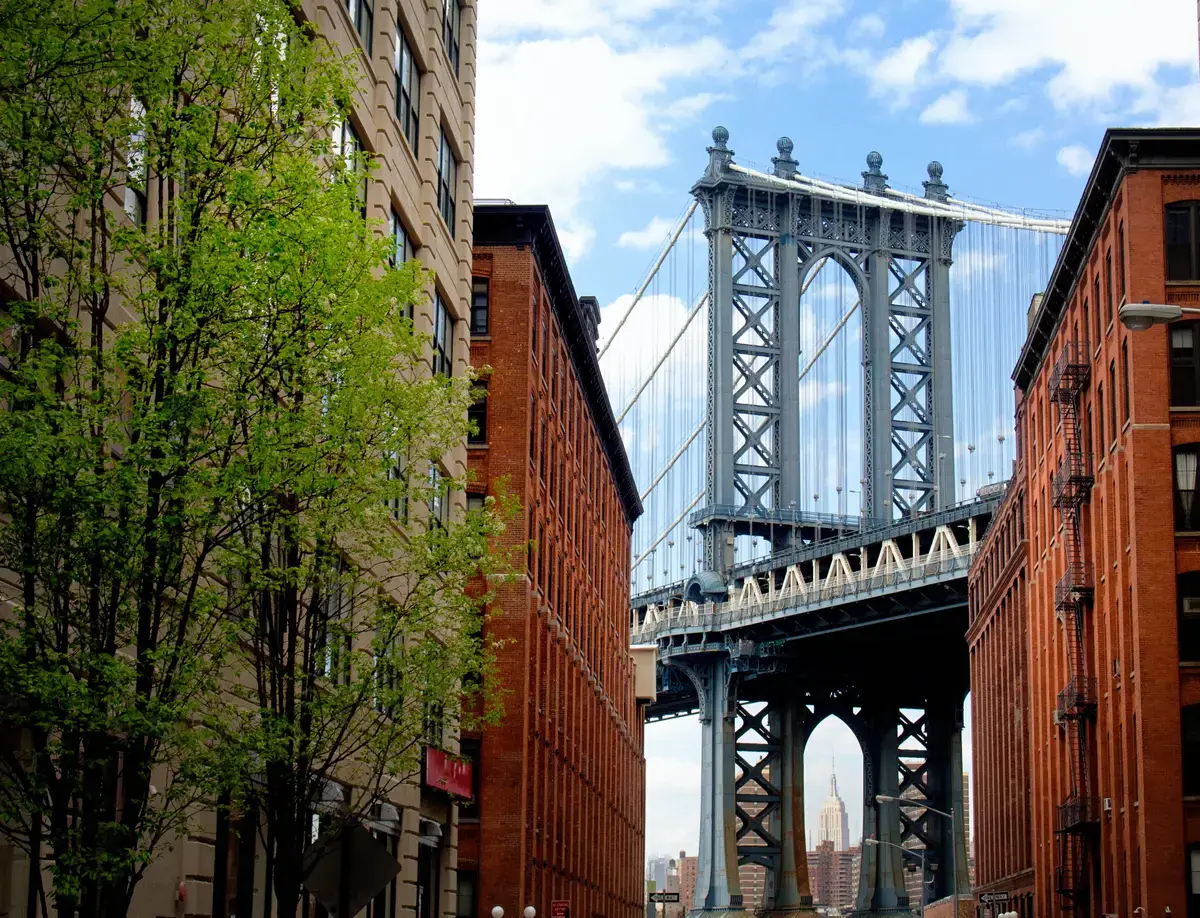 Manhattan Bridge framed between brick buildings